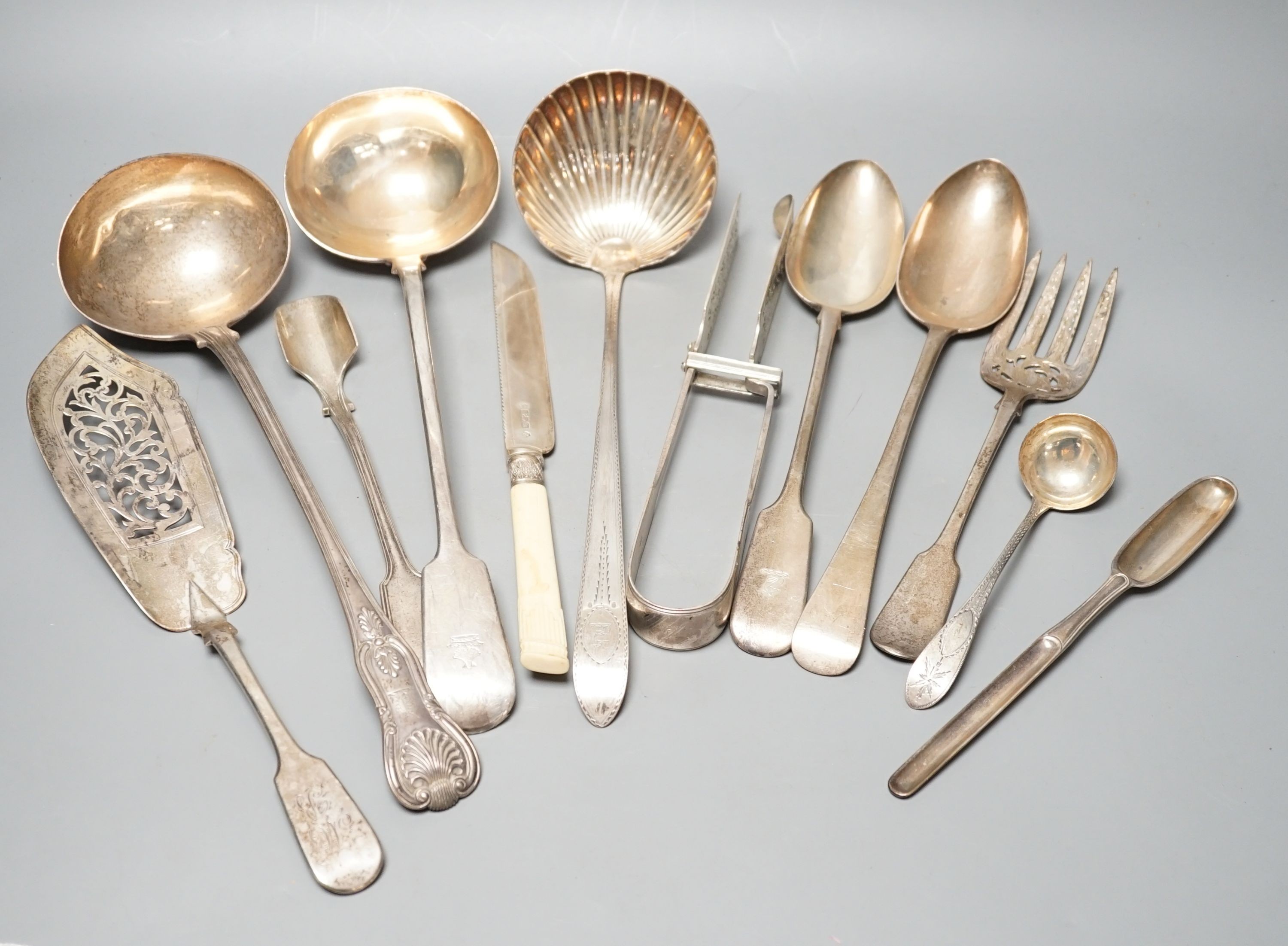 A George III Irish silver Celtic tip soup ladle, Dublin, 1789, A Georgian Irish silver marrow scoop, by William Walsh, two later Victorian silver soup ladles, a pair of Victorian silver asparagus tongs, two silver bastin